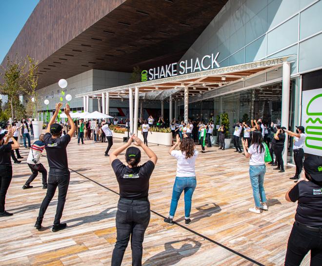 Employees clapping outside of Shake Shack
